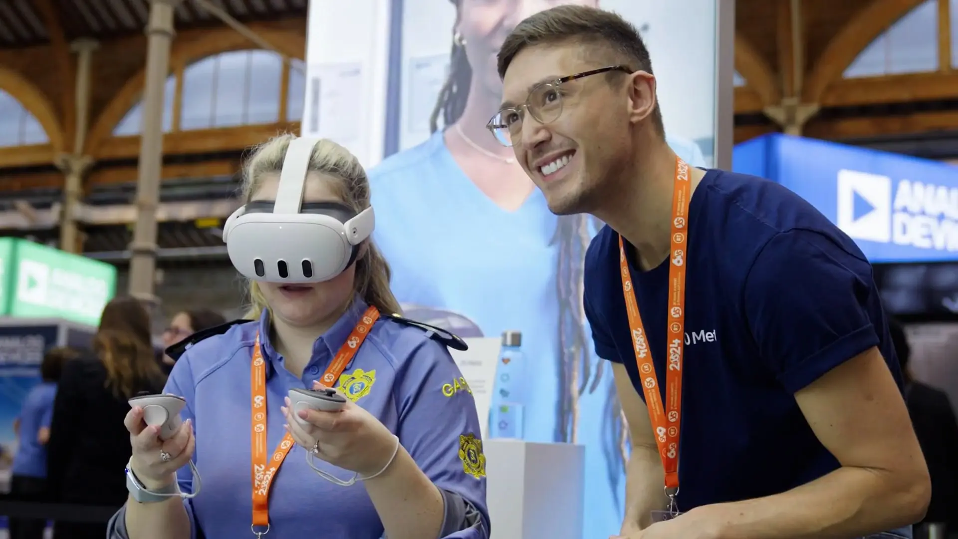 Two young people try out a VR headset at an exhibition.