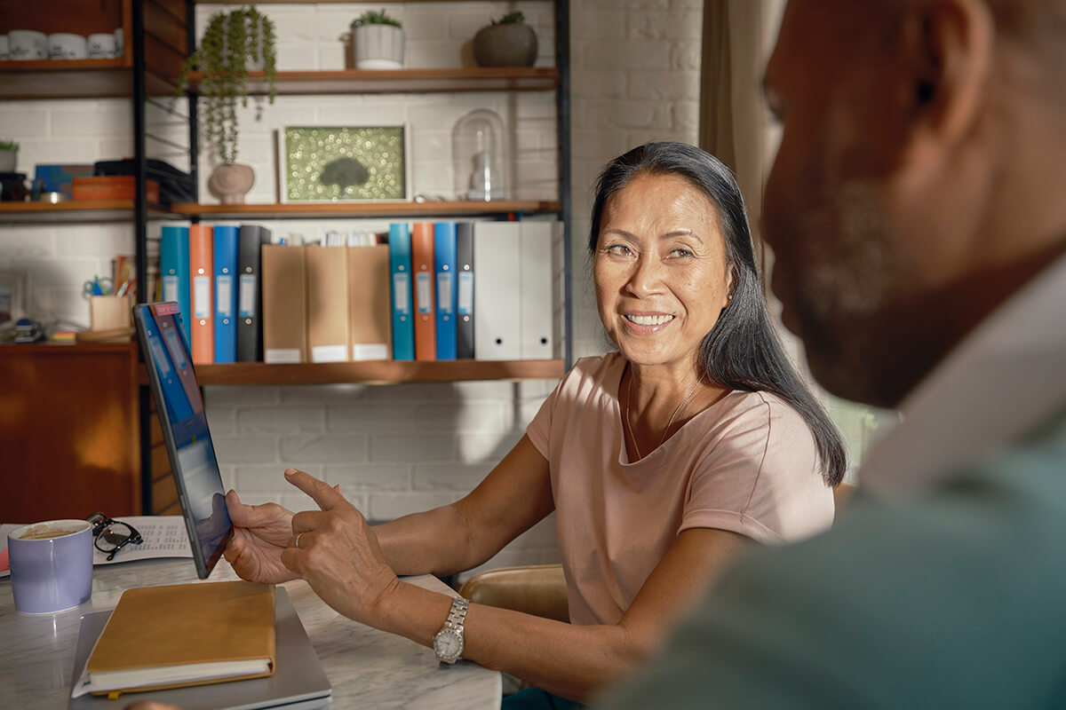 Woman and man looking at a tablet together